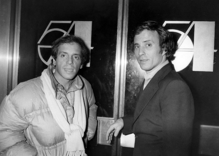 Steve Rubell (left) and Ian Schrager stand outside the door of Studio 54 in New York City, December 14, 1978. Credit: Photofest. 