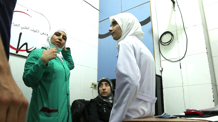 Al Ghouta, Syria - Nurse Samahar, Dr Amani and Dr Alaa working in a subterranean hospital in Syria to save the lives of victims of chemical and conventional weapons in the Syrian Civil War. (National Geographic)